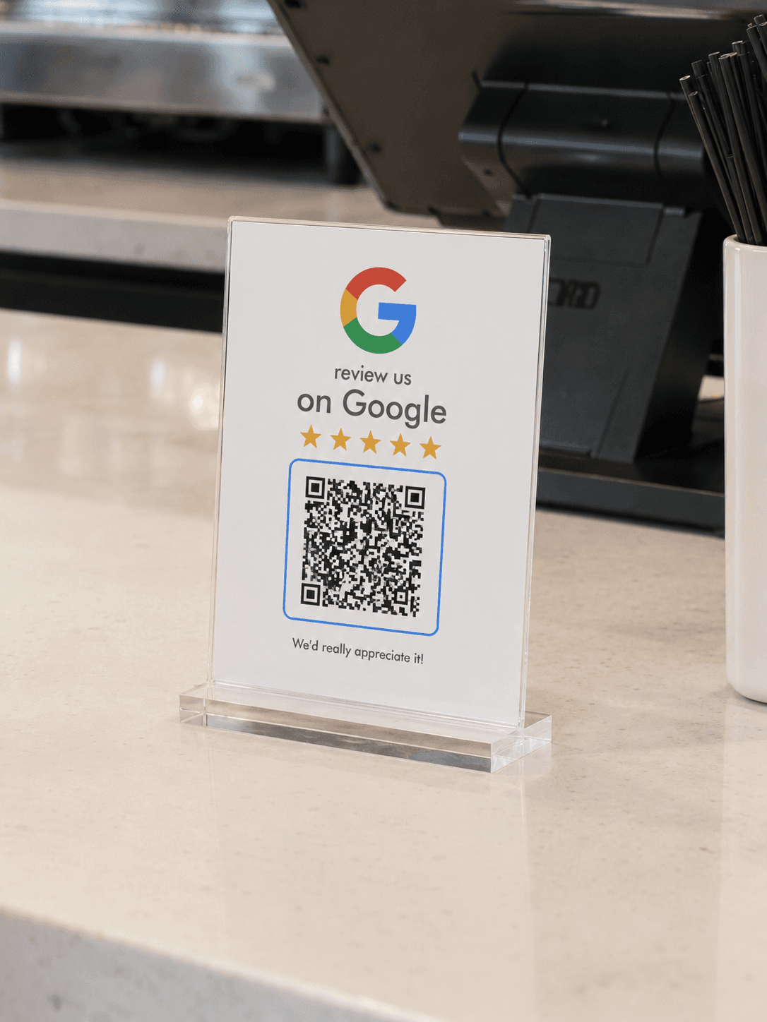Google Review QR Display in its acrylic holder on a checkout counter